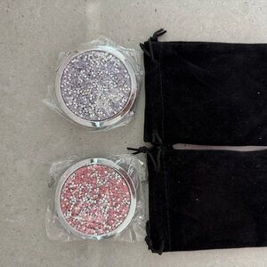 2 sparkly compact mirrors in pink and purple.